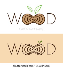 The word WOOD from a saw cut tree and green leaves. The concept of eco, lumber 