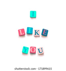 Words "i like you" with colorful blocks isolated on a white background. Description with bright cubes. Valentine's day card. Vector illustration EPS 10.