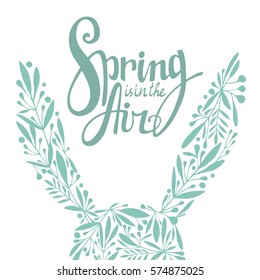 Words Spring is in the Air with rabbits floral ears. Vector season card. Hand lettering, typographic element for your design. Can be printed on T-shirts, bags, posters, invitations, cards, pillows.