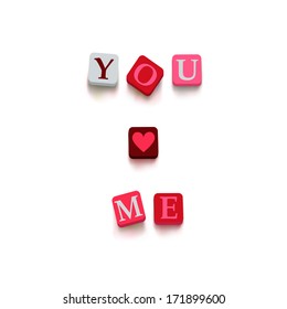 Words "you love me" with colorful blocks isolated on a white background. Description with bright cubes. Valentine's day card. Vector illustration EPS 10.