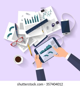 work concept - business concept - flat design - top view - digital tablet show a graphs of business change - set of paper that have a graphs and reports - desktop that contains a set of items - ideas 