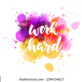 Work hard - handwritten modern calligraphy lettering text on abstract watercolor paint splash background.  Purple and orange colored