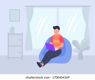 work from home concept with man working on laptop sitting on couch in living room