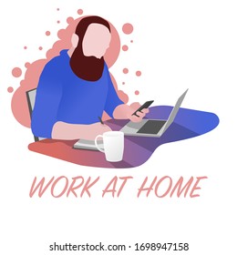 Work at home. Home Office. A man sits on a chair, at a table, has a telephone in one hand and works on a laptop from home. On the table is a cup of tea. Self-isolation. Quarantine.