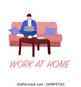 Work at home. Home Office. A man sits on a sofa and works on a laptop from home. Self isolation. Quarantine.