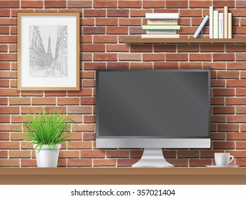 Work table, computer and shelves with books on brick wall background. Workplace in the office or at home.