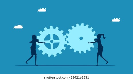work together Two businesswomen connecting gears
