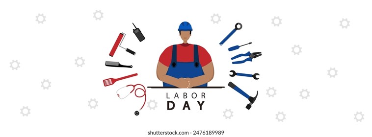 A worker in a construction helmet and various tools of various professions. Happy labor day.