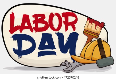 Worker equipment: safety helmet, brush, hammer and wrench with a sign with greeting message handwritten to commemorate Labor Day.