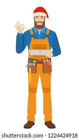 Worker in Santa hat holding digital tablet PC and showing a okay hand sign. Full length portrait of worker in a flat style. Vector illustration.