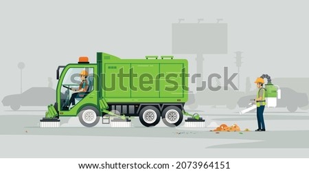 Workers and dust removal vehicles are cleaning the road.