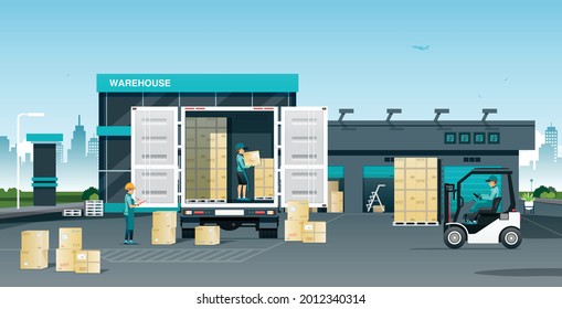 Workers loading goods onto trucks in a warehouse.