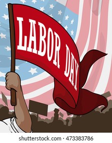 Workers in protest demanding better work rights in Labor Day march with American flag in the background.
