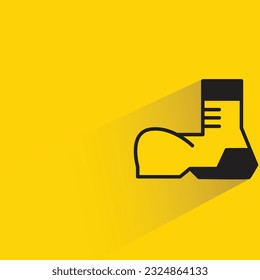 working boot with shadow on yellow background