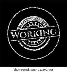 Working chalk emblem written on a blackboard