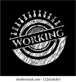 Working chalkboard emblem written on a blackboard