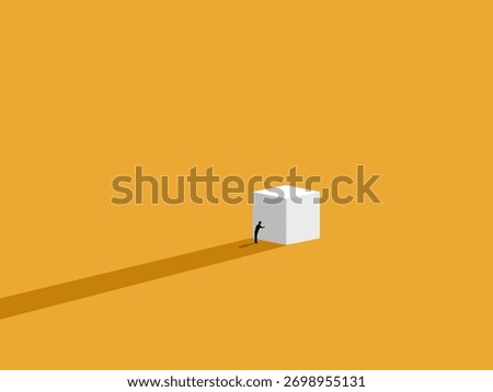 Working hard, a businessman tries to push a white box