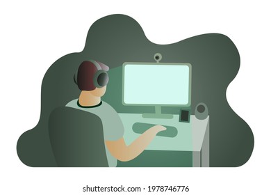 Working From Home. The man is sitting at the table. A young man works from home. The guy in front of the computer. Green cloud, evening, night. 