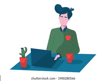 a working man at a computer,blue table,cactus with red flower and red mug . The idea of website design, postcard, posters.a young, successful, smiling man in a green sweater with red flecks. 