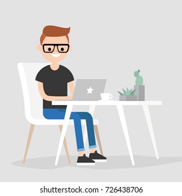 Working space. Young male character typing on a laptop / flat editable vector illustration, clip art