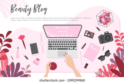 Workplace of beauty blogger, view from above, desktop, laptop, camera, cosmetics, phone and flowers