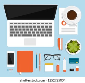 Workplace for business, management and IT. View from above. Laptop, mobile phone, notebook and office supplies on the desktop