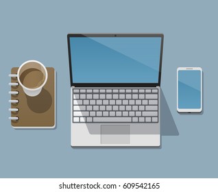Workplace of a businessman, programmer, designer or freelancer with a laptop, workbook, smartphone and a cup of coffee. View from above