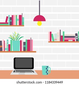Workplace. Computer and bookshelves on a brick wall