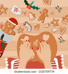 Workplace concept. Top view with textured table, gingerbread, fir branches, Christmas toys, balls, hands, Christmas decorations,  candy, lollipop, flower, gift