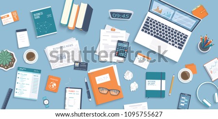 Workplace Desktop background. Top view of table, laptop, folder, documents, notepad, business card, purse, calendar, clock, books,coffee, passport, crumpled paper. Business background, organization. 