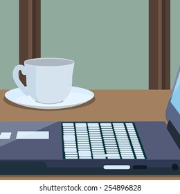 Workplace with a part of laptop and cup of coffee