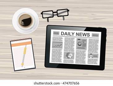 Workplace with tablet pc showing daily news and a cup of coffee on a wooden work table 
