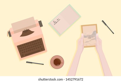 Workplace with a typewriter in a minimalist style. The girl is considering an old photo.