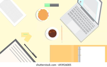 Workplace in yellow tones. Business snack include coffee and burger.