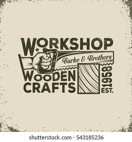 Workshop of the Joiner or Carpenter Vintage Logo - Hand Holding a Saw and Sawing of Wood. Vector illustration - worn texture and background on separate layers, can be disable, easy to edit.