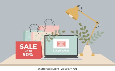 Workspace decorated for a online flash sale promotion featuring a laptop, shopping bags, and a stylish lamp.