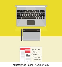 Workspace of an illustrator, with a Laptop and graphic tablet