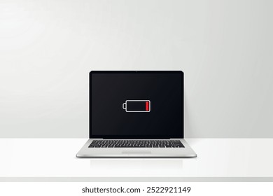 Espacio de trabajo con el ordenador portátil baja señal de la batería en la pantalla