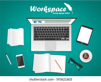 workspace with laptop, phone, notebook and stationery