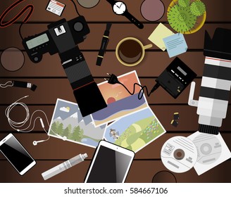Workspace of photographer. Top view with brown table, photo camera, lens, smartphone, tablet and coffee cup. Flat design. Vector illustration with clipping mask.