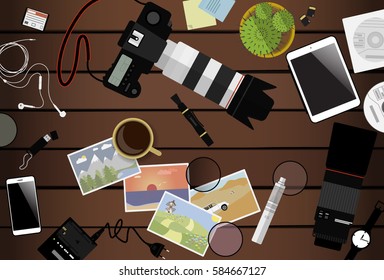 Workspace of photographer. Top view with brown table, photo camera, lens, smartphone, tablet and coffee cup. Flat design. Vector illustration with clipping mask.