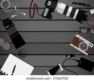 Workspace of photographer. Top view with gray table, photo camera, lens, smartphone, notepad and portable hard drive. Flat design. Vector illustration with clipping mask.
