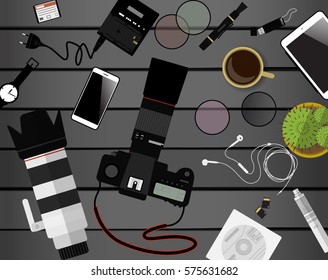 Workspace of photographer. Top view with gray table, photo camera, lens, smartphone, notepad and portable hard drive. Flat design. Vector illustration with clipping mask.