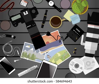Workspace of photographer. Top view with gray table, photo camera, lens, smartphone, tablet and coffee cup. Flat design. Vector illustration with clipping mask.