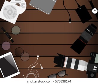 Workspace of photographer. Top view with textured table, photo camera, lens,tablet, notepad and earphones. Flat design. Vector illustration with clipping mask.