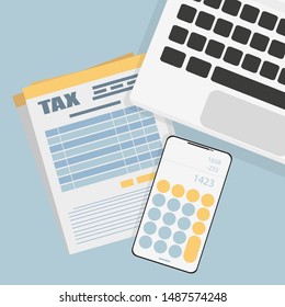 workspace, tax form laptop and phone on the table