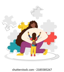 World Autism Awareness Day. Illustration a girl hugs a child in a flat cartoon style. Background with puzzles. The girl is wearing a sweatshirt with puzzles.