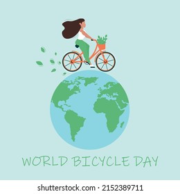 World Bicycle Day concept. The girl rides a bicycle on the globe.