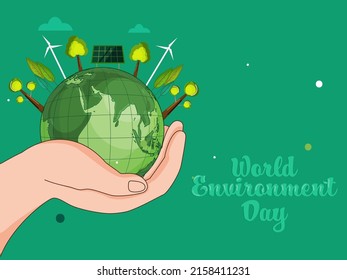 Concepto Del Día Mundial Del Medio Ambiente Con La Mano Humana Sostengo Globe De La Tierra, Árboles, Molinos De Viento, Paneles Solares Sobre Fondo Verde.
