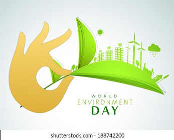 World Environment Day concept with illustration of a urban city created on green leaves holding by human hands on grey background. 